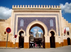 Marrakech vs Fes: A wide panoramic view of the ancient Fes el Bali medina from the Merenid Tombs, emphasizing its vastness and complexity.
